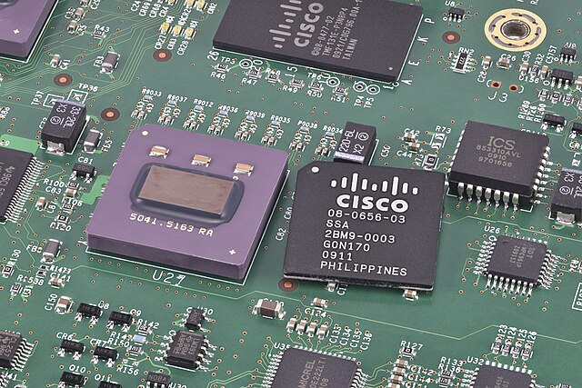 Image of a Cisco serial link transceiver ASIC, by Martijn Boer of Wikimedia Commons in the public domain